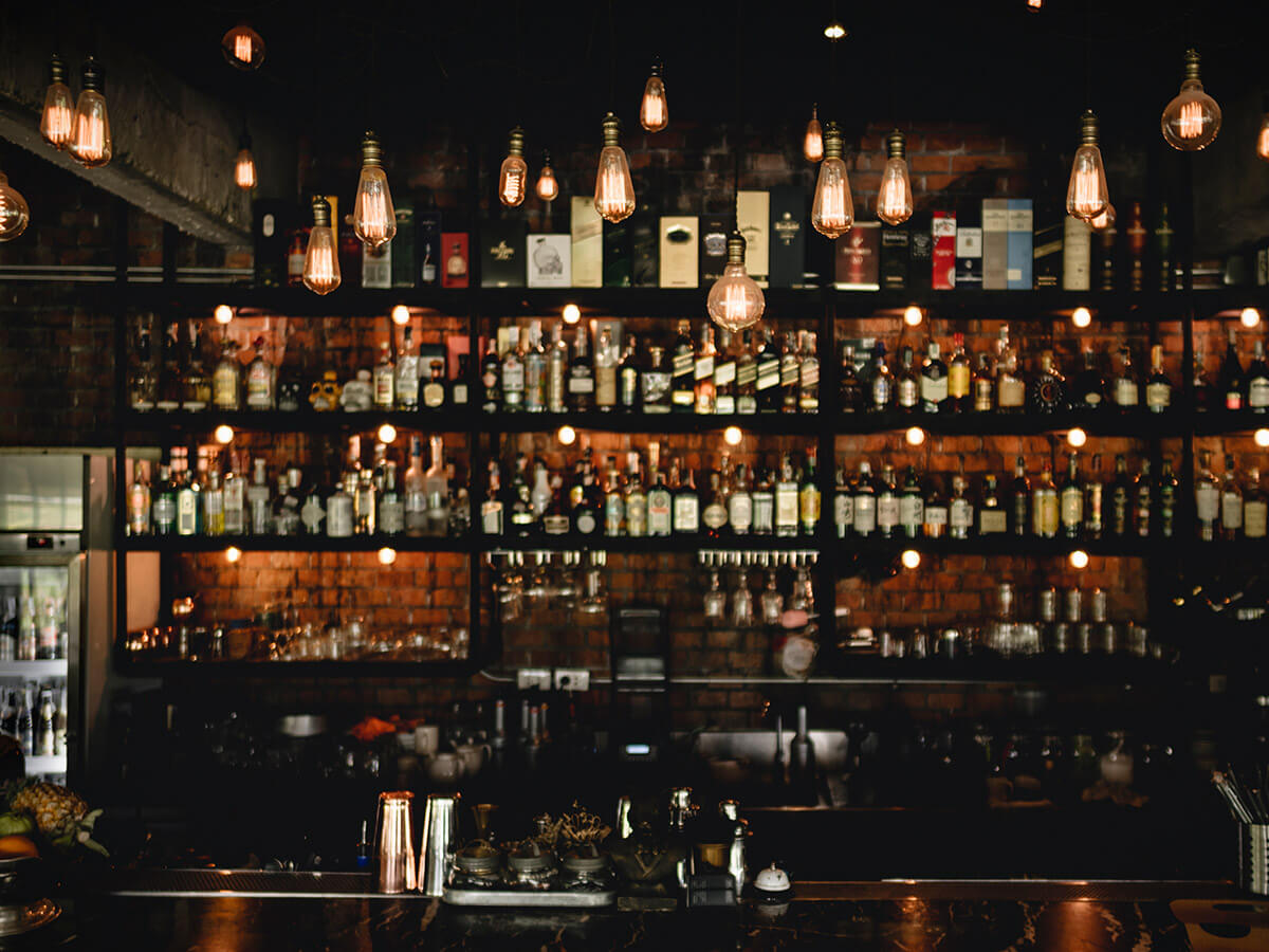 Bartender serving drinks at a busy bar